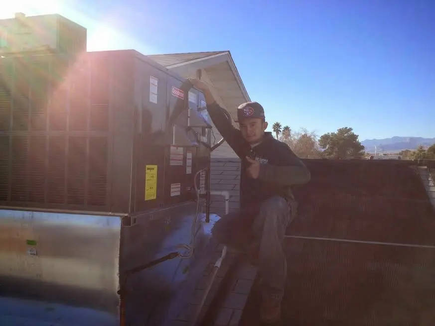 HVAC technician performing HVAC Inspection on a rooftop unit in West Hanover